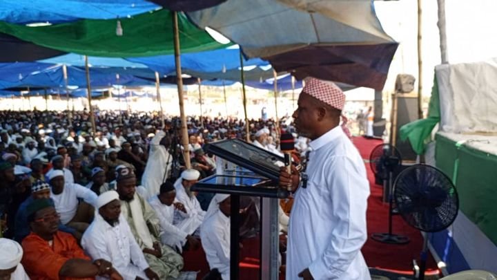 Speaker addressing the gathering from a podium