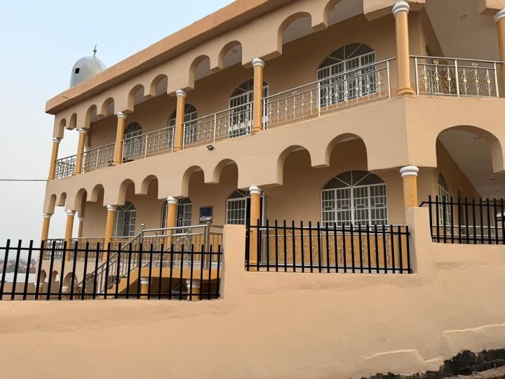 The masjid building, two storeys with arched balconies